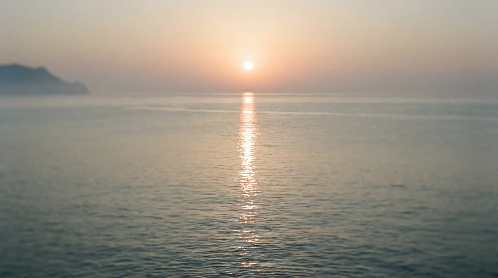 The sun meeting the Mediterranean, its gold path laid across calm water